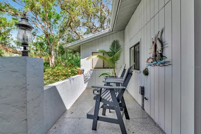 a view of backyard with outdoor seating and stairs