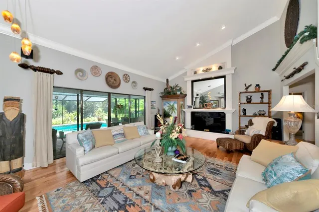 a living room with furniture a large window and a fireplace