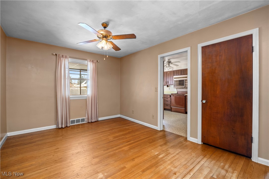 25950 Bagley Road Olmsted Falls, OH 44138 - Photo 6 of 32 Unfurnished bedroom featuring light wood finished floors and a ceiling fan