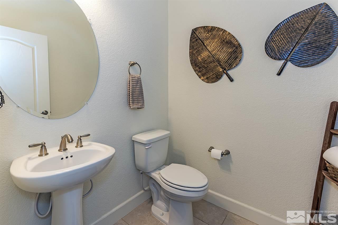10350 Culiacan Pass Trail Reno, NV 89521 - Photo 14 of 20 a bathroom with a toilet a sink and mirror