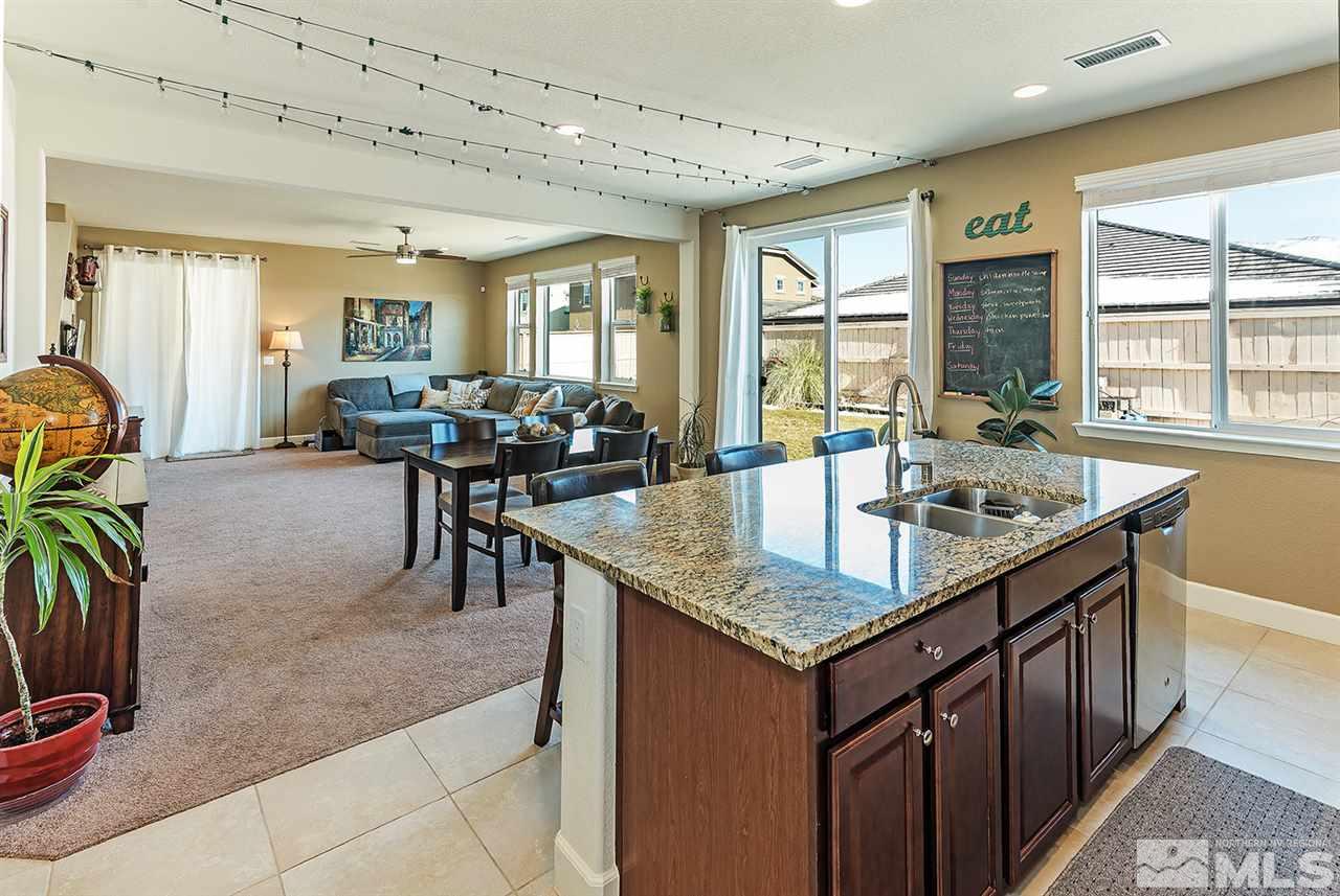10350 Culiacan Pass Trail Reno, NV 89521 - Photo 8 of 20 a kitchen with center island table and chairs