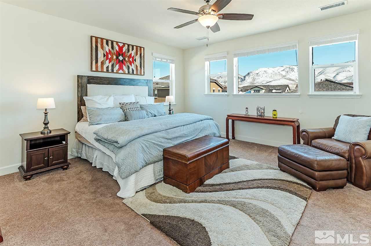 10350 Culiacan Pass Trail Reno, NV 89521 - Photo 9 of 20 a bedroom with furniture and a chandelier