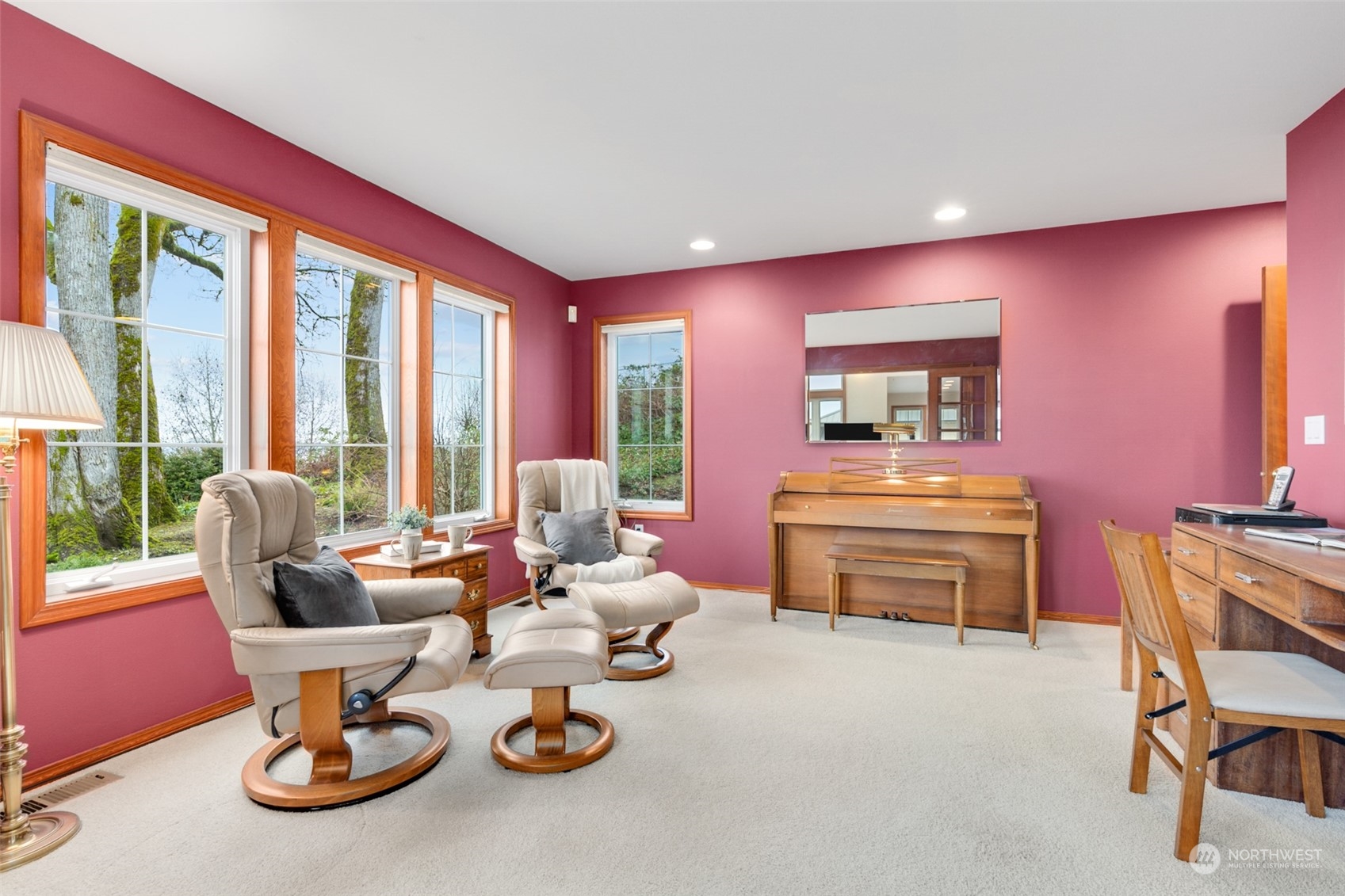 9942 Johnson Point Road Northeast Olympia, WA 98516 - Photo 13 of 34 a living room with furniture a flat screen tv and a floor to ceiling window