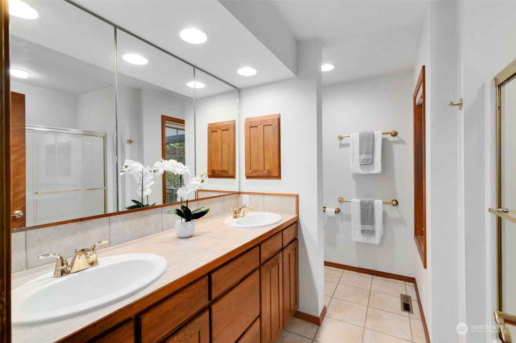 9942 Johnson Point Road Northeast Olympia, WA 98516 - Photo 16 of 34 a bathroom with a sink double vanity and a mirror