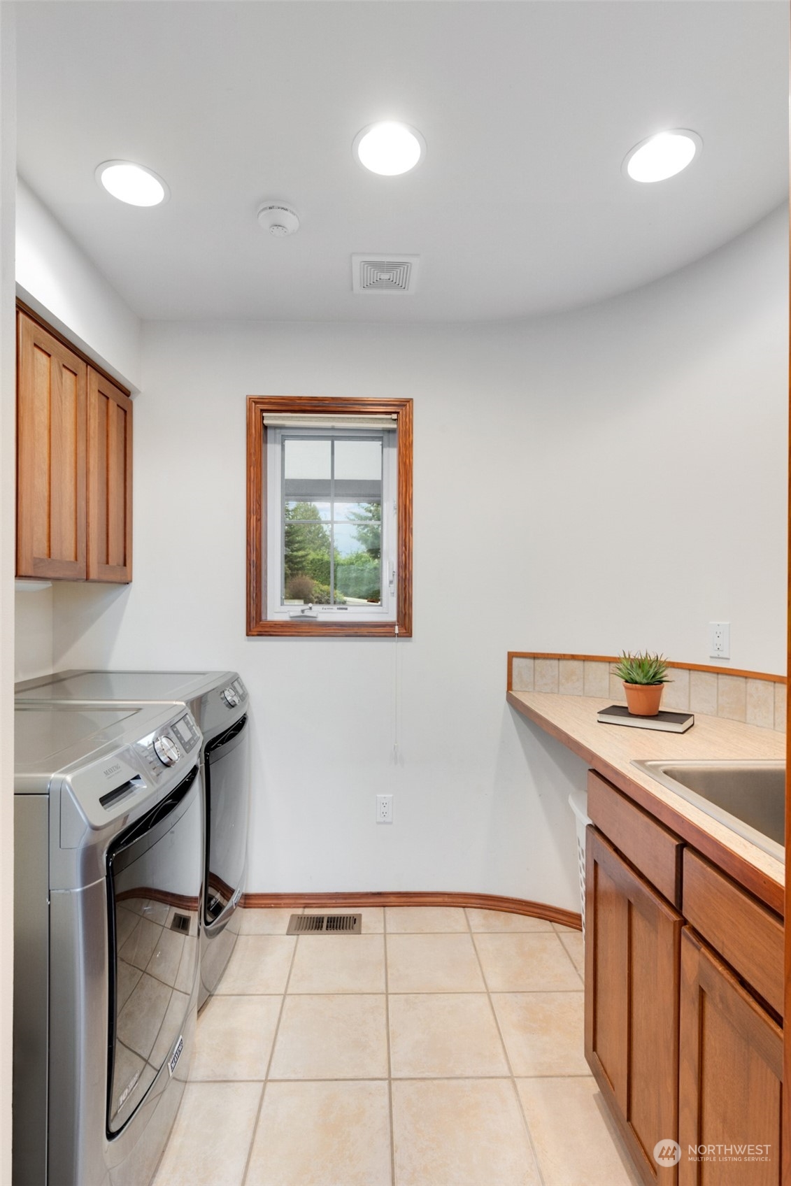 9942 Johnson Point Road Northeast Olympia, WA 98516 - Photo 17 of 34 a view of cabinets with wooden floor and furniture