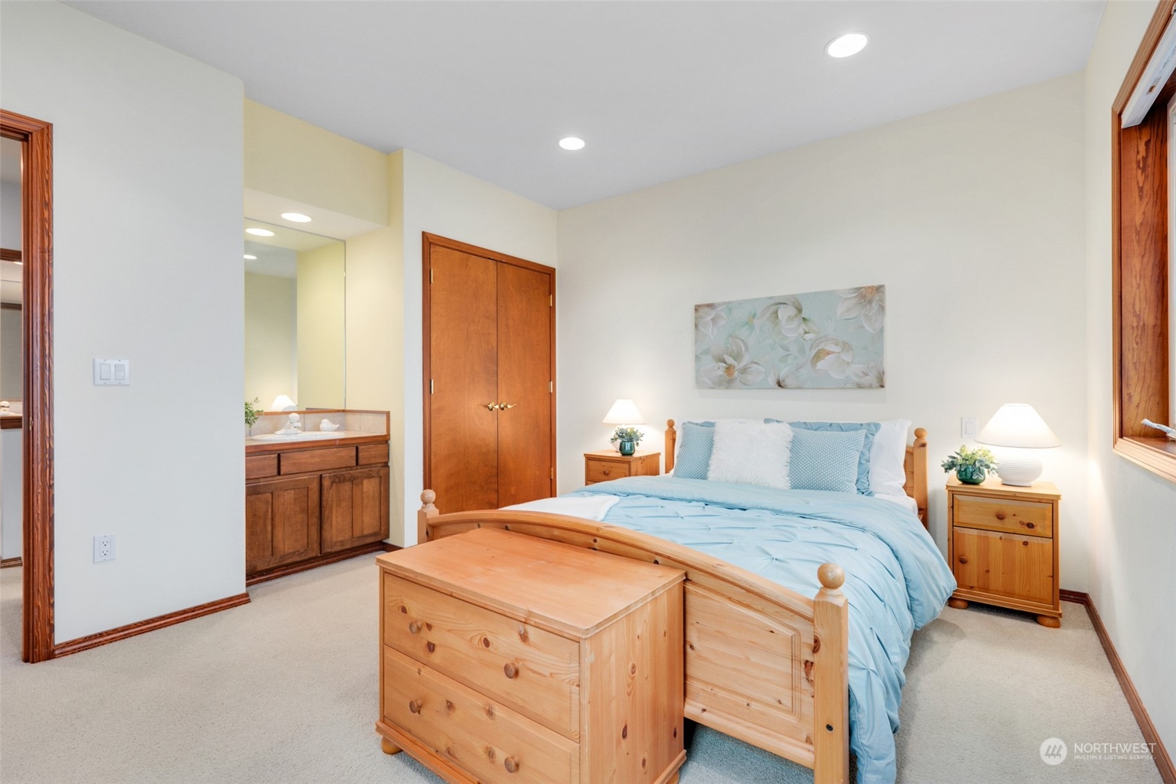 9942 Johnson Point Road Northeast Olympia, WA 98516 - Photo 21 of 34 a bedroom with a bed and a table in it