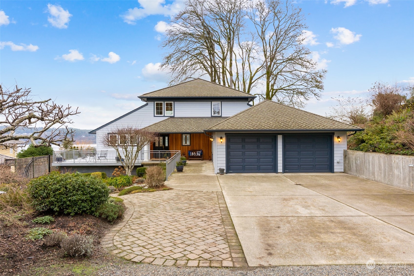 9942 Johnson Point Road Northeast Olympia, WA 98516 - Photo 28 of 34 a front view of a house with yard and trees