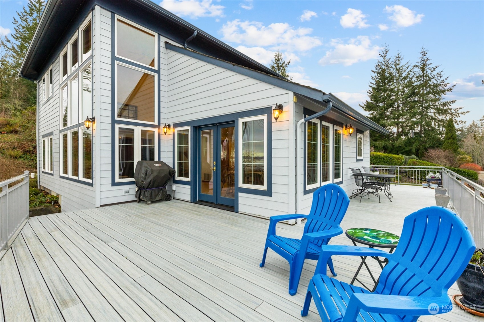 9942 Johnson Point Road Northeast Olympia, WA 98516 - Photo 31 of 34 a view of a patio with table and chairs with wooden floor and fence