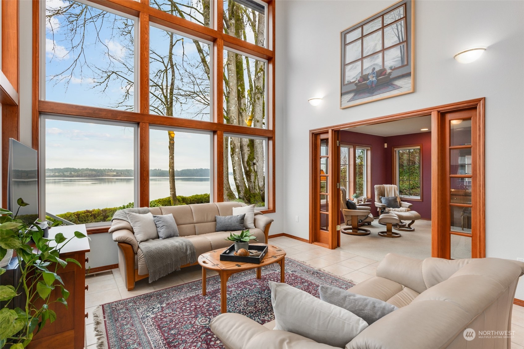 9942 Johnson Point Road Northeast Olympia, WA 98516 - Photo 4 of 34 a living room with furniture and a large window with outer view