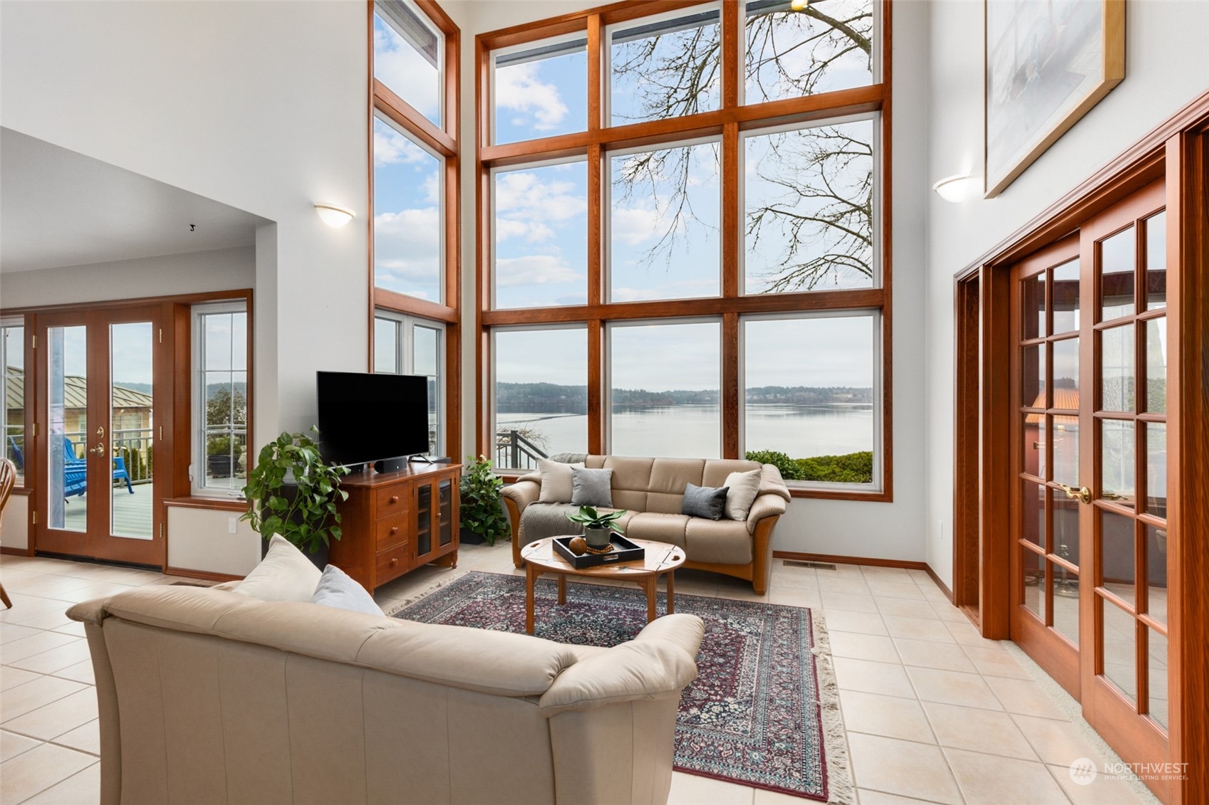 9942 Johnson Point Road Northeast Olympia, WA 98516 - Photo 5 of 34 a living room with furniture tv and a large window