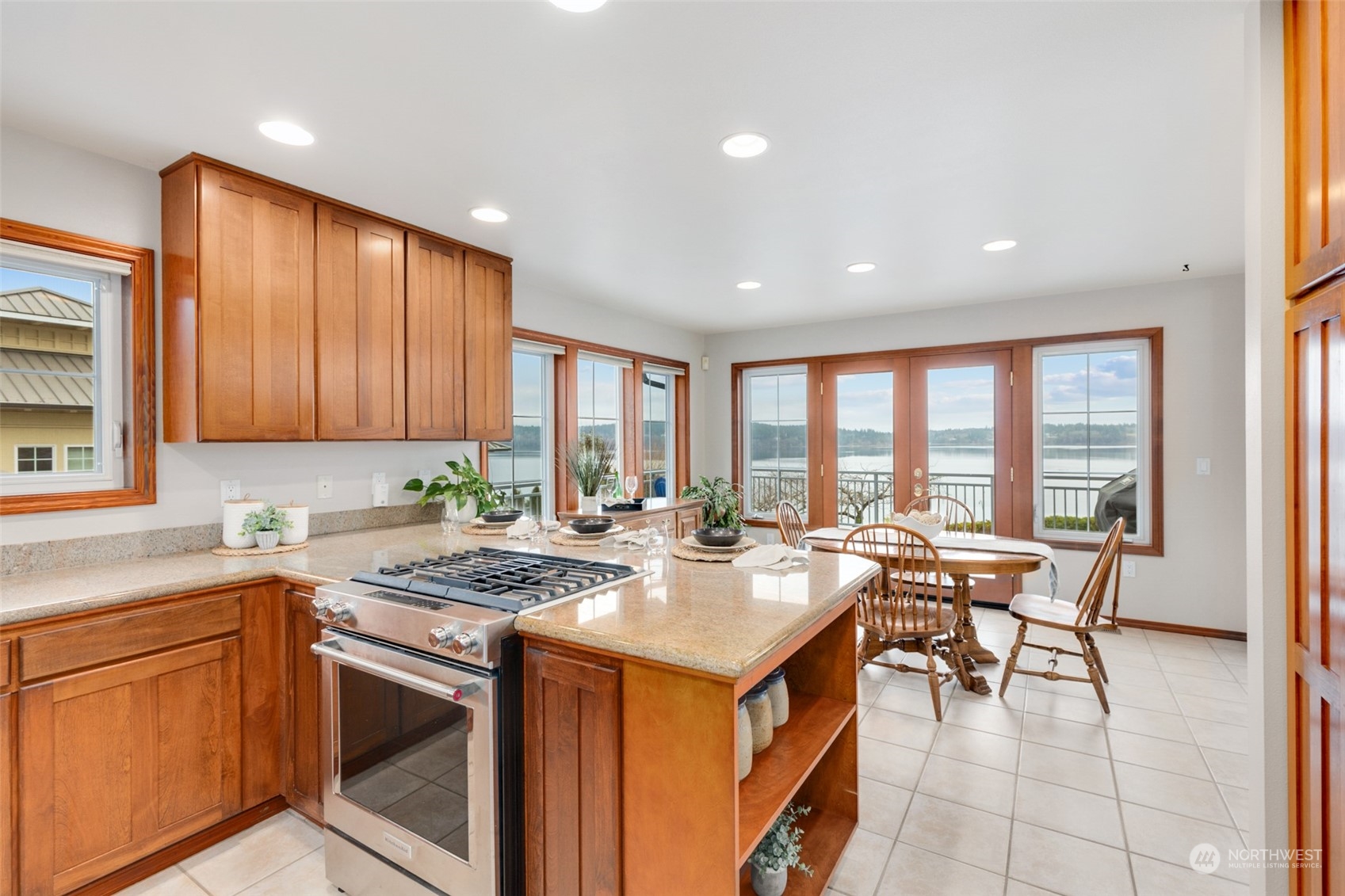 9942 Johnson Point Road Northeast Olympia, WA 98516 - Photo 7 of 34 a kitchen with a stove a sink and a refrigerator