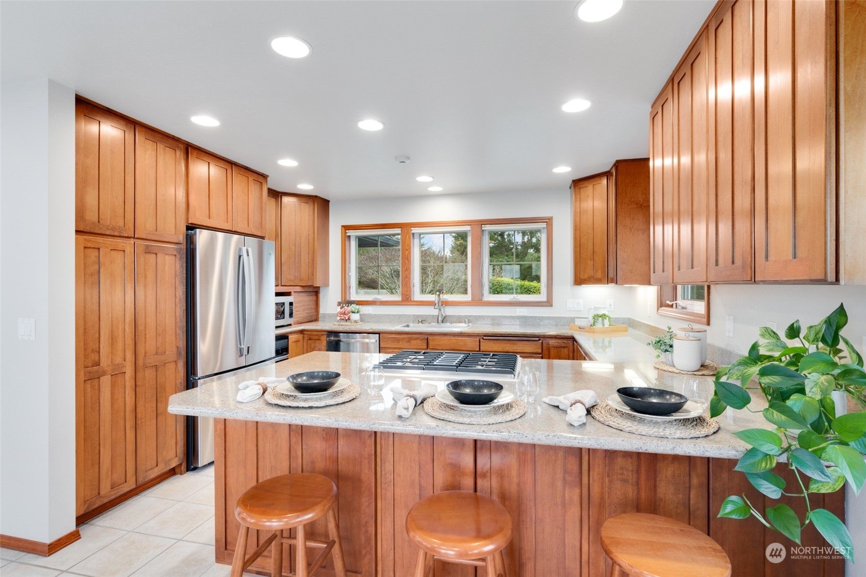 9942 Johnson Point Road Northeast Olympia, WA 98516 - Photo 9 of 34 a kitchen with stainless steel appliances granite countertop sink stove refrigerator and cabinets