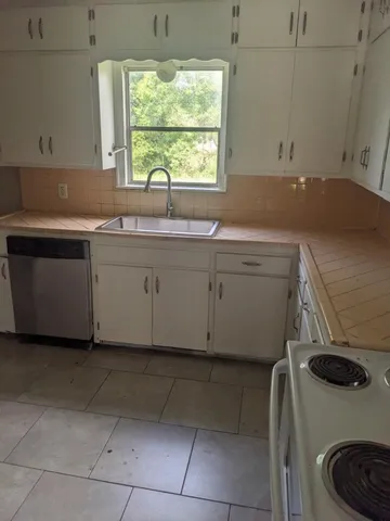 a room with a sink and a washing machine