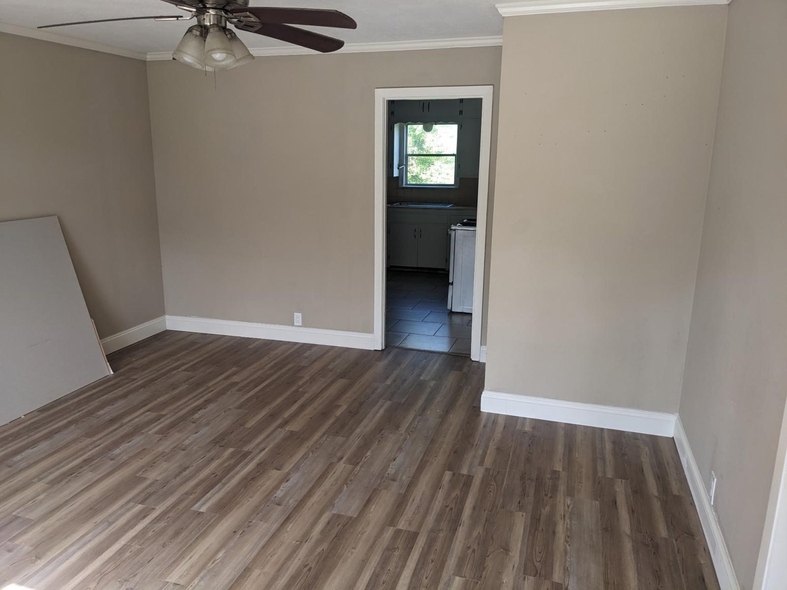 3470 Kipling Drive Beaumont, TX 77706 - Photo 13 of 21 a view of a room with wooden floor a ceiling fan and window