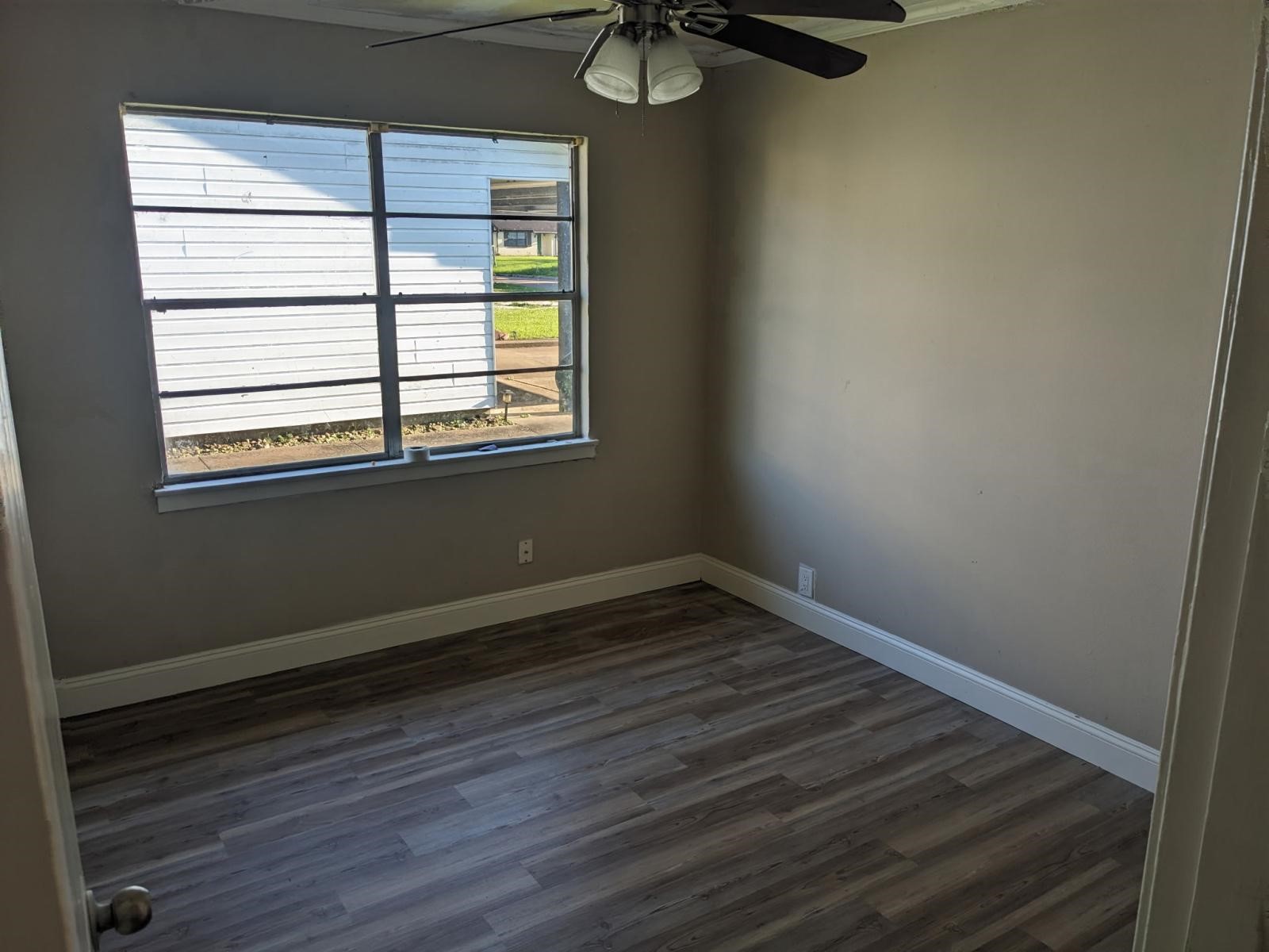 3470 Kipling Drive Beaumont, TX 77706 - Photo 20 of 21 a view of an empty room with wooden floor and a window