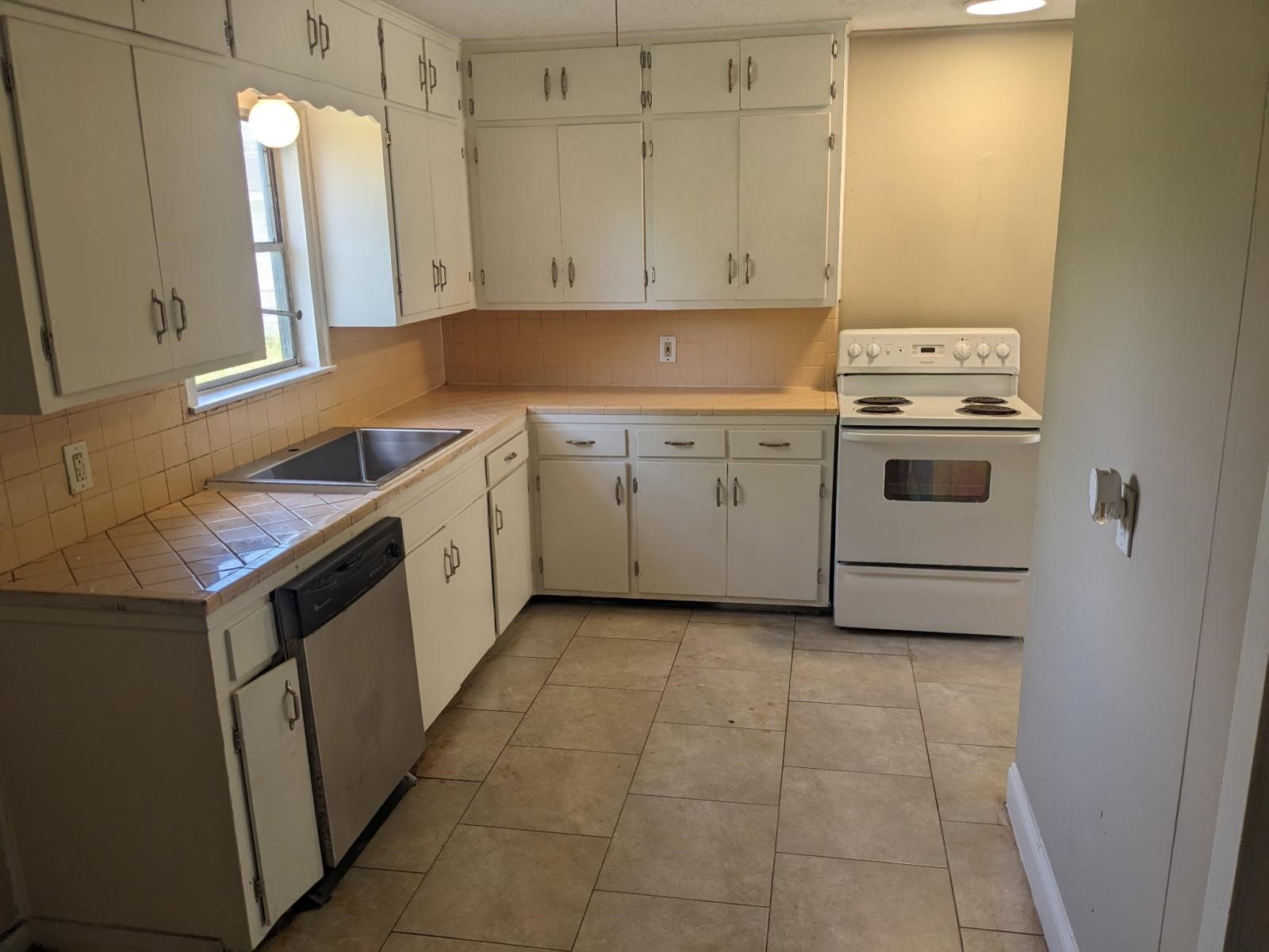 3470 Kipling Drive Beaumont, TX 77706 - Photo 3 of 21 a kitchen with a stove sink and cabinets