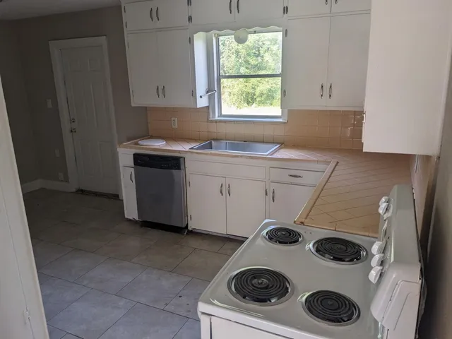 a kitchen with a stove and a microwave