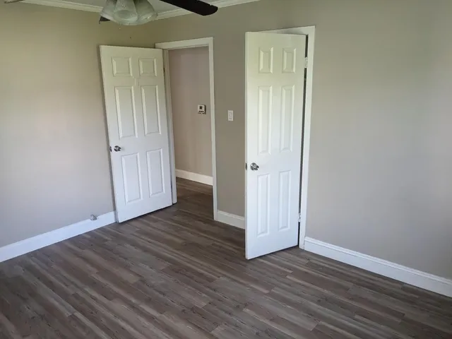a view of a hallway with wooden floor