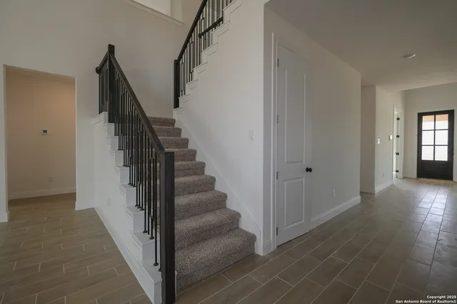 a view of a hallway with wooden floor and entryway