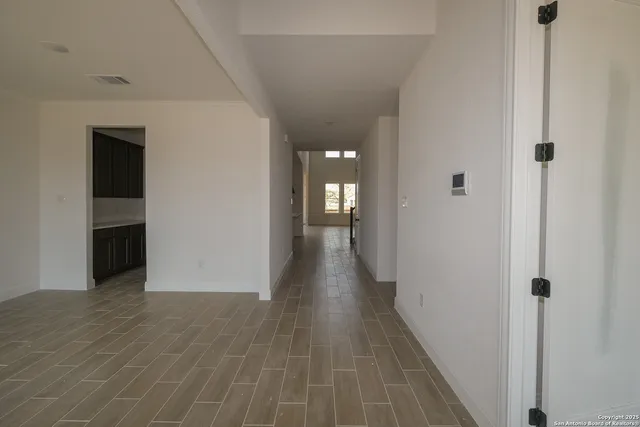 a view of a hallway with wooden floor