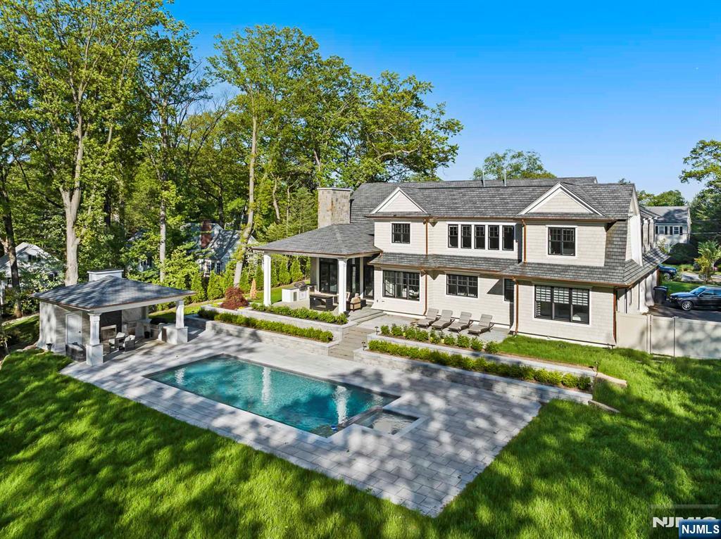 396 Knollwood Road Ridgewood, NJ 07450 - Photo 11 of 50 a front view of a house with swimming pool having outdoor seating