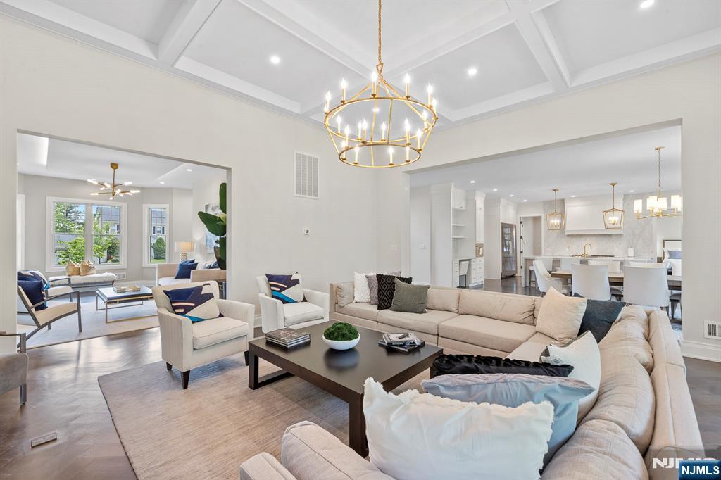 396 Knollwood Road Ridgewood, NJ 07450 - Photo 16 of 50 a living room with lots of furniture and a chandelier