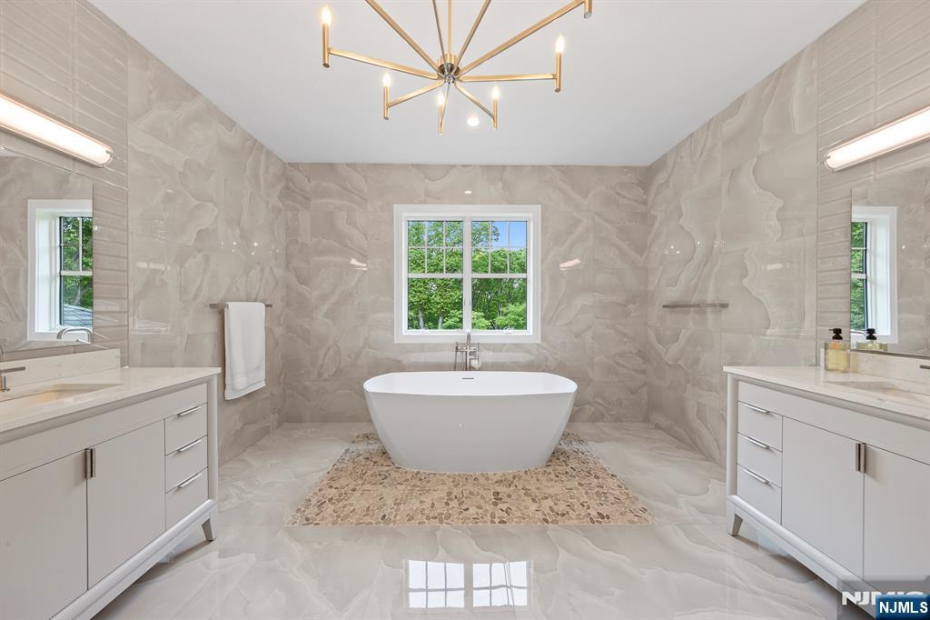 396 Knollwood Road Ridgewood, NJ 07450 - Photo 39 of 50 a bathroom with a sink toilet a mirror and window