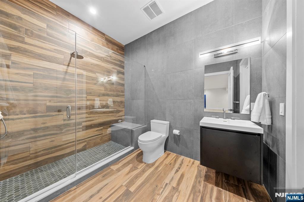 396 Knollwood Road Ridgewood, NJ 07450 - Photo 46 of 50 a bathroom with a sink a toilet and shower