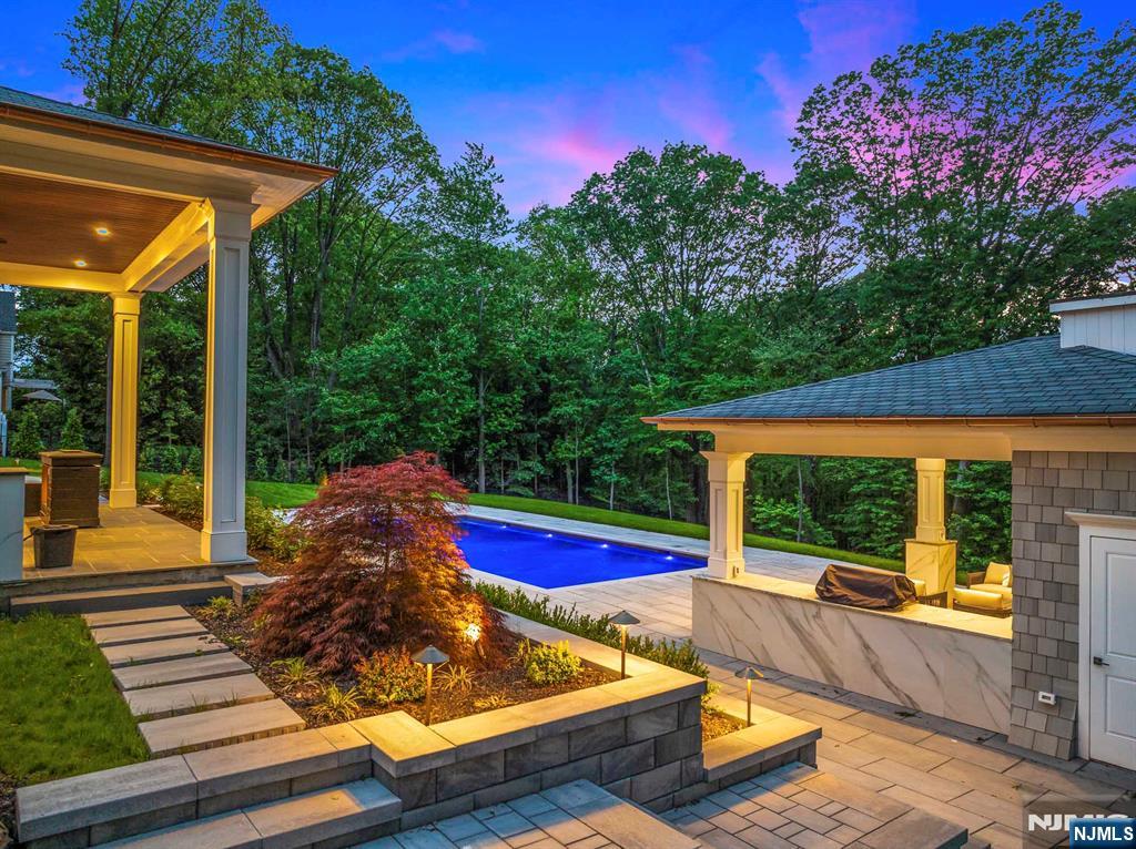 396 Knollwood Road Ridgewood, NJ 07450 - Photo 6 of 50 a view of backyard with swimming pool and outdoor seating