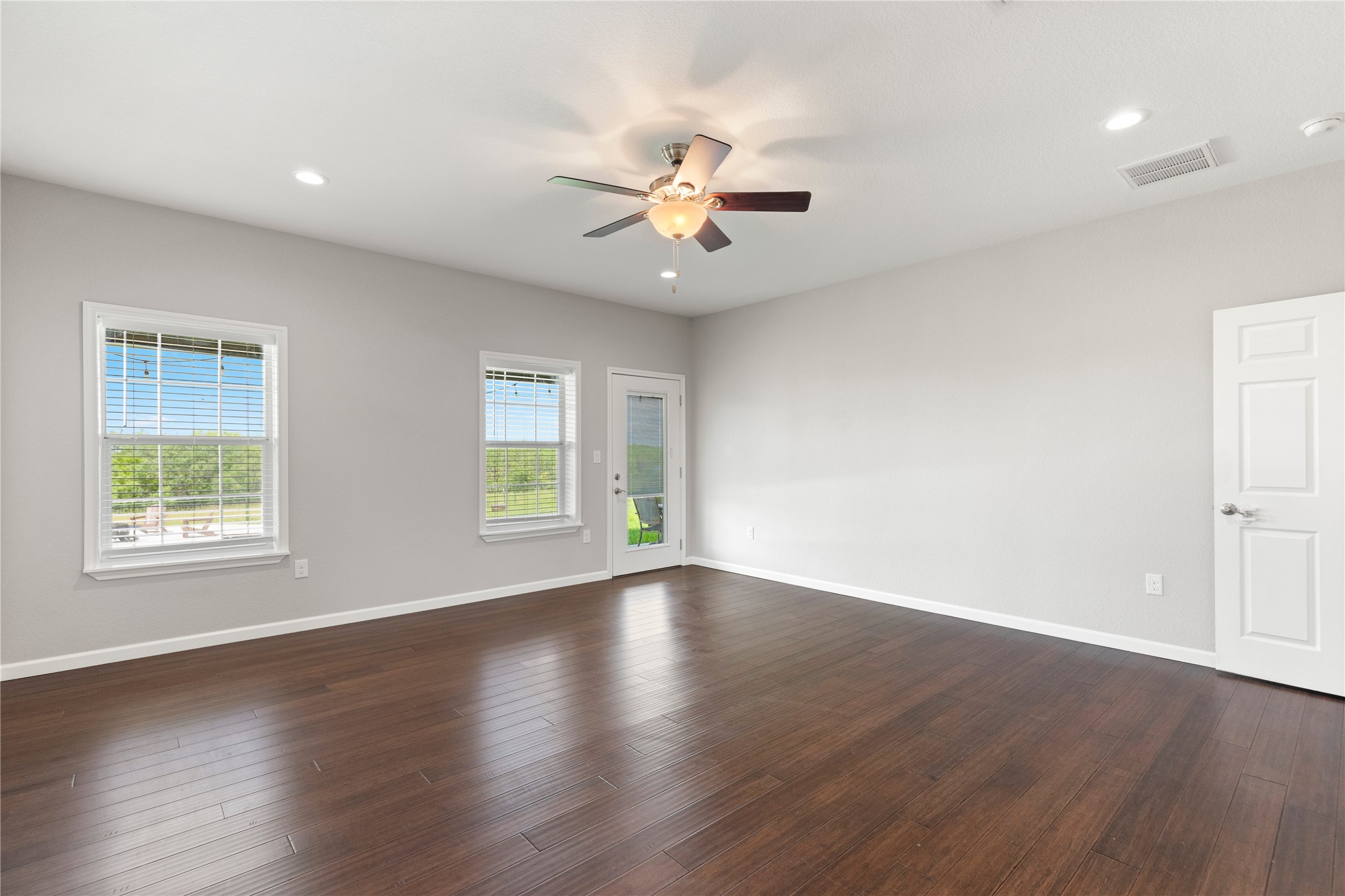 1293 Pioneer Road Seguin, TX 78155 - Photo 15 of 40 Rich hardwood floors complement this spacious room with abundant natural light and outdoor access.