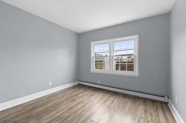 a bedroom with a bed and a refrigerator