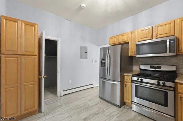 a view of hallway with closet and wooden floor