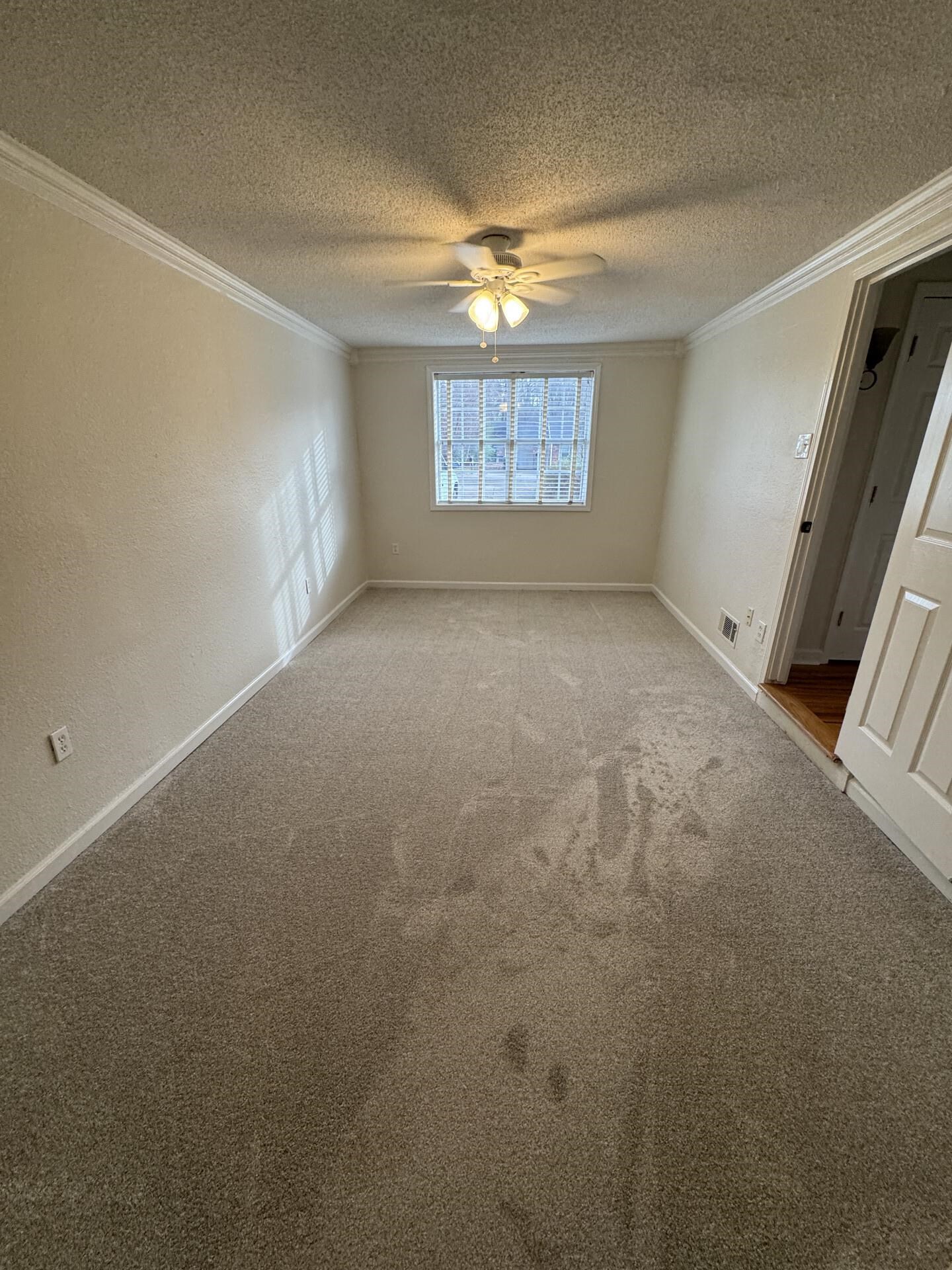2823 Elmore Park Road Bartlett, TN 38134 - Photo 11 of 22 Empty room featuring carpet flooring, a ceiling fan, ornamental molding, a textured wall, and a textured ceiling