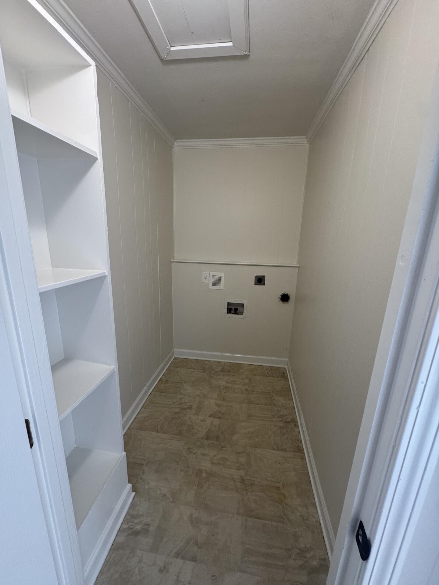 2823 Elmore Park Road Bartlett, TN 38134 - Photo 13 of 22 Laundry room featuring electric dryer hookup, light flooring, and ornamental molding