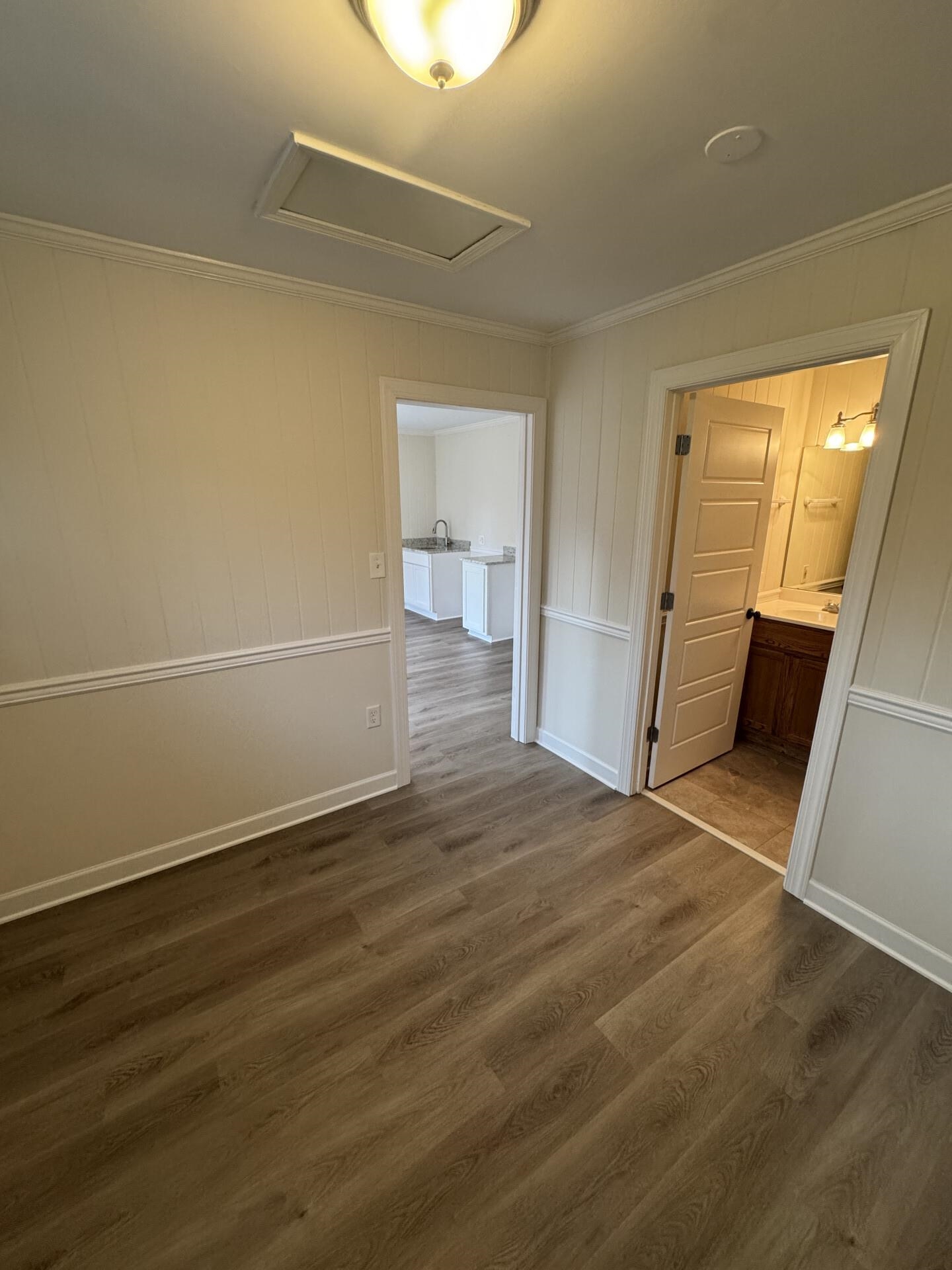 2823 Elmore Park Road Bartlett, TN 38134 - Photo 22 of 22 Unfurnished bedroom with dark wood finished floors, ensuite bath, and crown molding