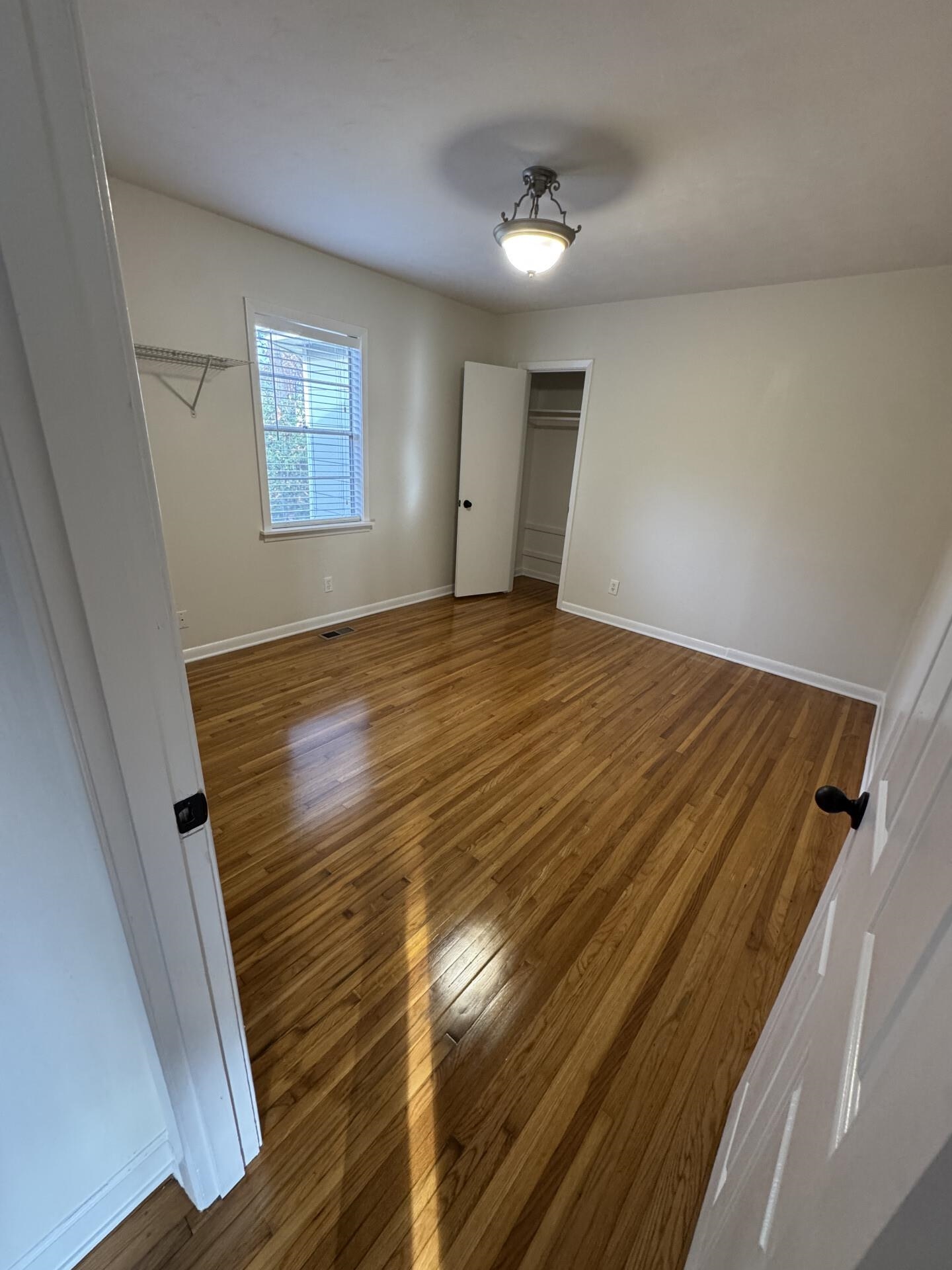 2823 Elmore Park Road Bartlett, TN 38134 - Photo 9 of 22 Unfurnished bedroom featuring wood-type flooring and baseboards