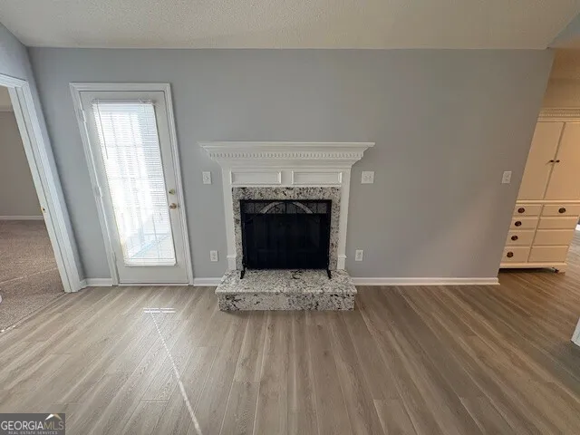 a view of fireplace and wooden floor