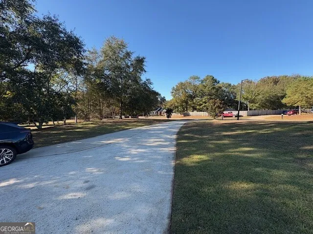 a view of empty room with wooden floor and fireplace