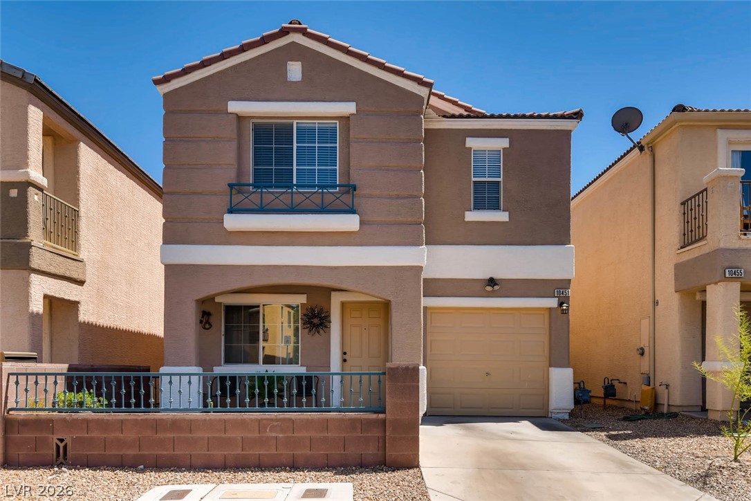 10451 Processor Court Las Vegas, NV 89129 - Photo 2 of 28 A well-maintained stucco facade with a red tile roof creates inviting curb appeal.