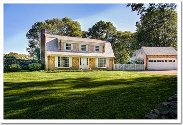 a front view of a house with a garden