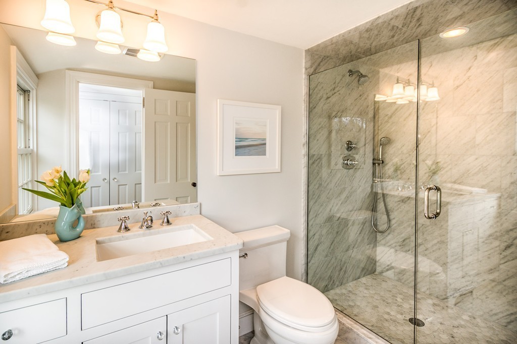 95 Gannett Road Scituate, MA 02066 - Photo 22 of 30 a bathroom with a sink a toilet and shower