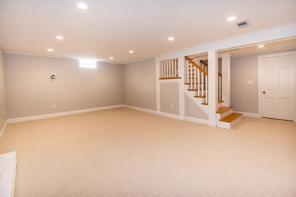 95 Gannett Road Scituate, MA 02066 - Photo 25 of 30 an empty room with wooden floor and white walls