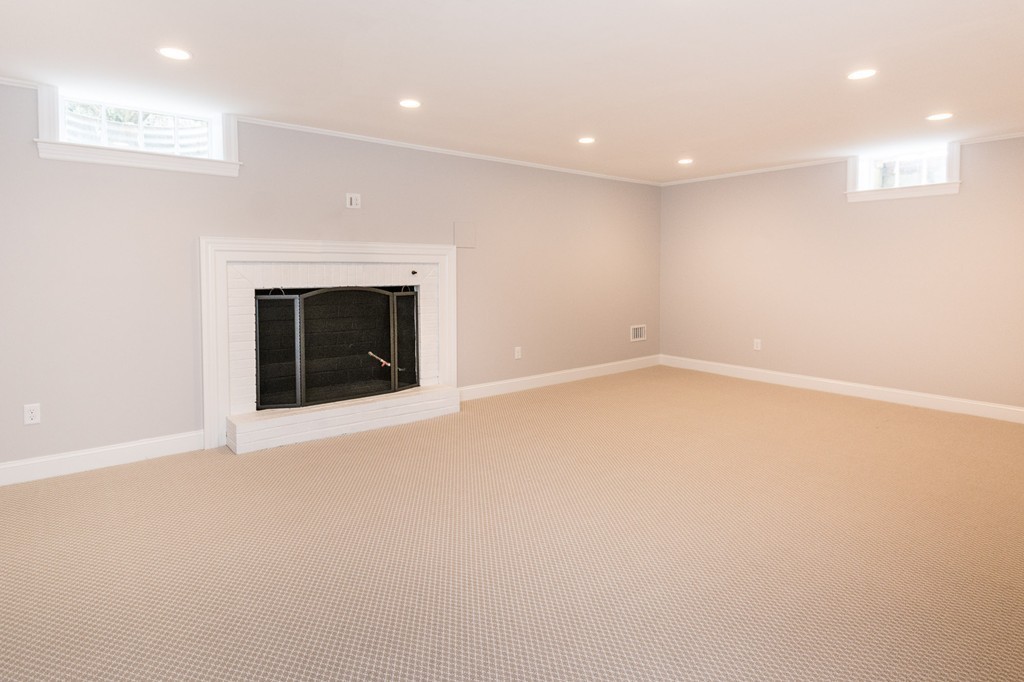 95 Gannett Road Scituate, MA 02066 - Photo 26 of 30 an empty room with a fireplace