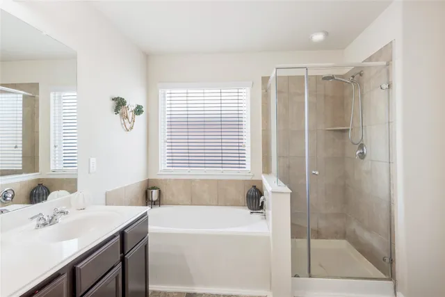a bathroom with a bathtub shower sink and a toilet