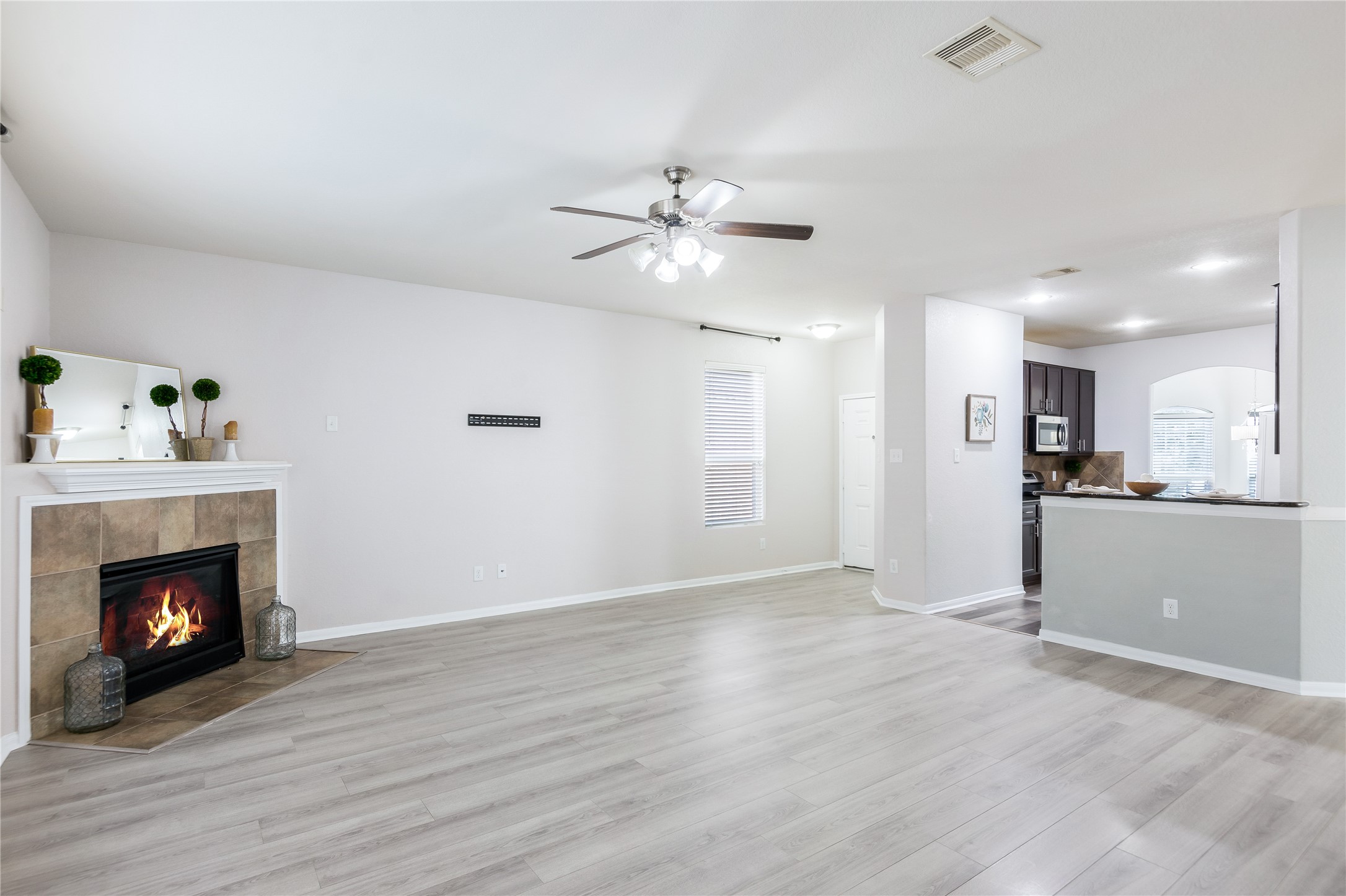 15007 Holland Grove Court Cypress, TX 77433 - Photo 2 of 28 a view of an empty room with kitchen and fireplace