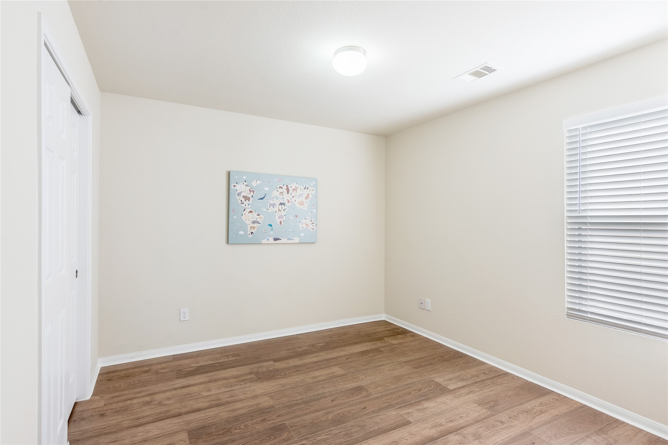 15007 Holland Grove Court Cypress, TX 77433 - Photo 21 of 28 an empty room with wooden floor and windows