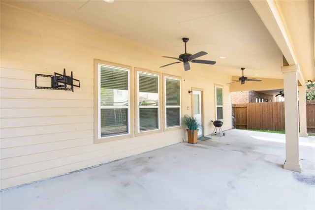 an empty room with entrance and a ceiling fan