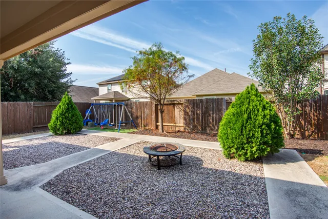 a backyard of a house with yard and outdoor seating