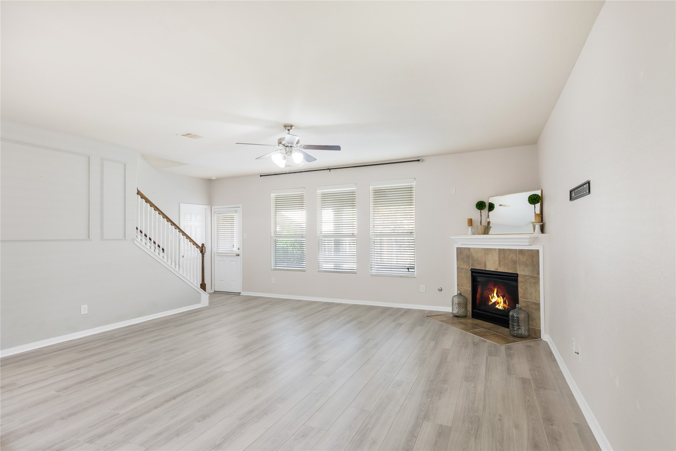 15007 Holland Grove Court Cypress, TX 77433 - Photo 3 of 28 a view of an empty room with wooden floor fireplace and a window