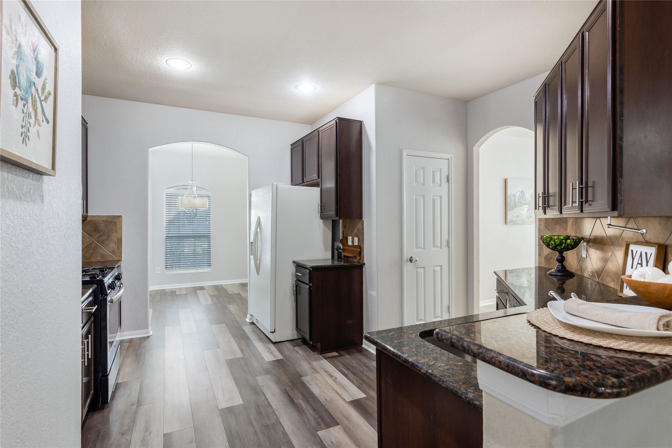 15007 Holland Grove Court Cypress, TX 77433 - Photo 7 of 28 a kitchen with stainless steel appliances granite countertop a refrigerator and a stove